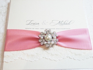 lace wedding invitation with dusky pink ribbon
